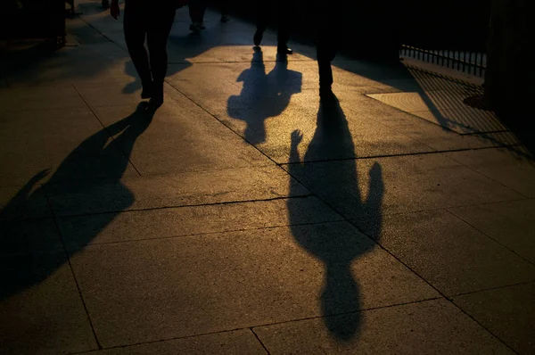 Shadows of walking people — стоковое фото