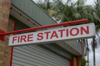 View of an Fire Station sign hanging in front of the statin in Bangalow, NSW, Australia clipart