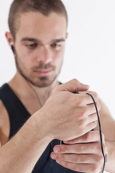 Young athlete checking out his playlist — Stock fotografie