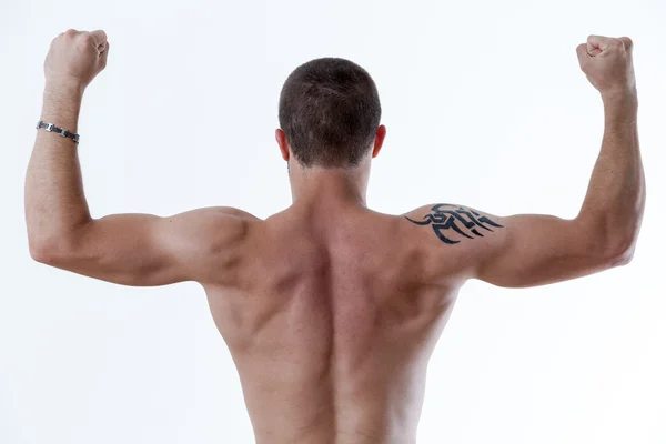 Man from behind raising up his arms — Stockfoto