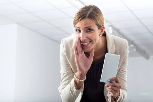 The office gossipmonger whispering her news — Stock Photo, Image