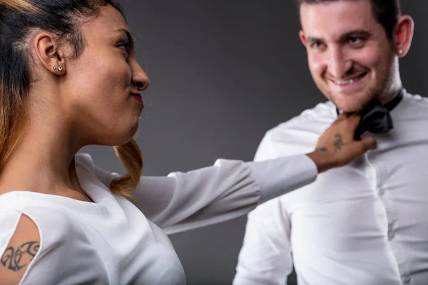 Woman looking to his man and taking him by the tie — Stock Photo, Image