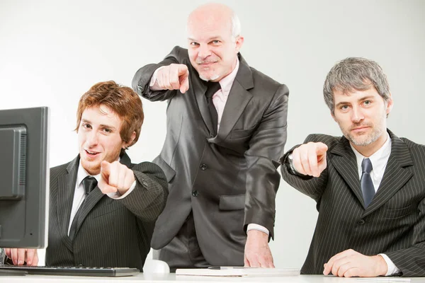 Three thrilled businessmen pointing out to you — Stock Photo, Image