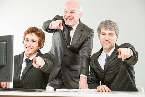 Three thrilled businessmen pointing out to you — Stock Photo, Image