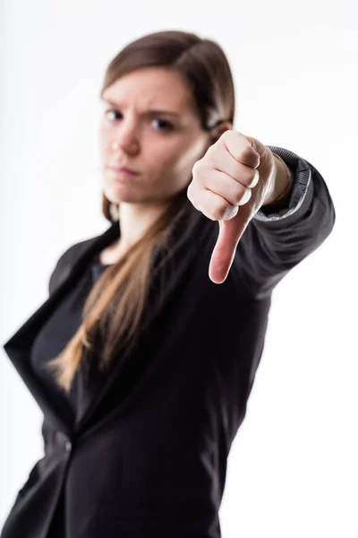 Thumb down of a woman blurred in the background — Stock Photo, Image