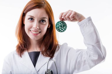 medical doctor holding a christmas ball clipart