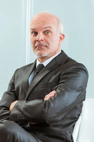 Businessman with arms folded and a funny face — Stock Photo, Image