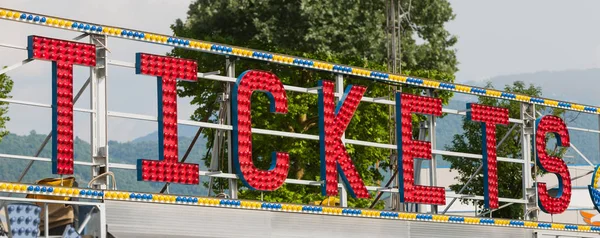 electric TICKETS sign on a scaffolding