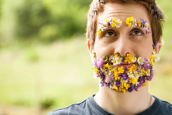Portrait of a guy with flowers instead of his beard — Stock Photo, Image