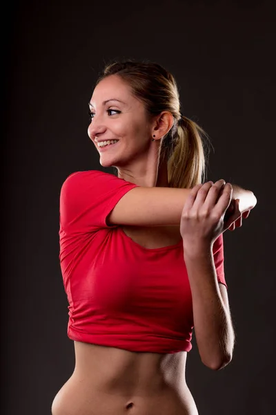 Biceps arm strækker motion af en kvinde - Stock-foto