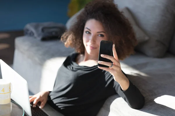 Attraktiv kvinna tar hennes selfie på en mobiltelefon — Stockfoto
