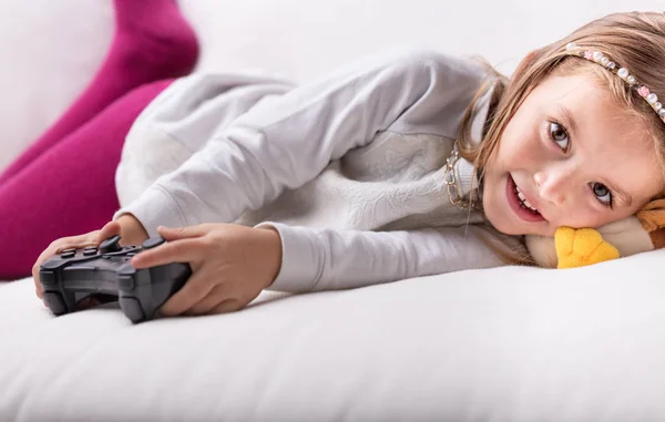 Cute pretty little girl lying resting on her bed — Stock Photo, Image