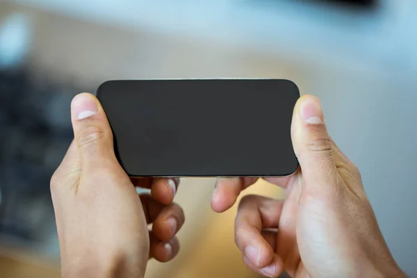 Focus on a smartphone in horizontal position — Stock Photo, Image
