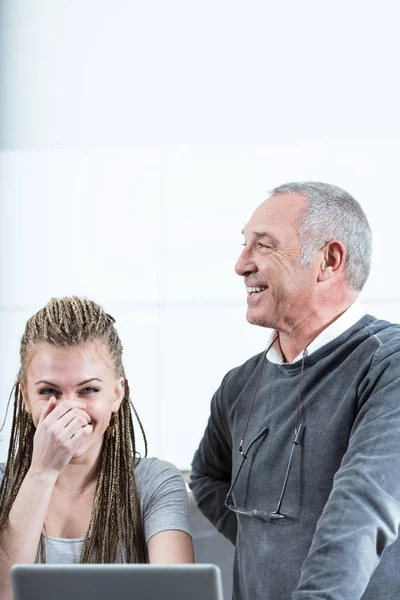 Young woman and senior man laughing — Stock Photo, Image