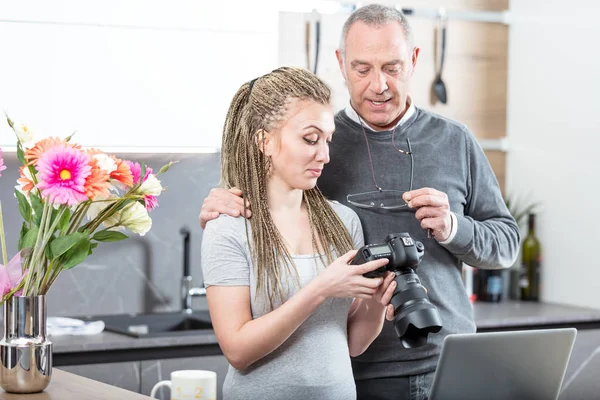 Daughter showg photographs to her father — Stock Photo, Image