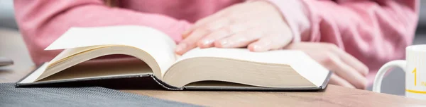 Hands of a girl on a book — Stock Photo, Image