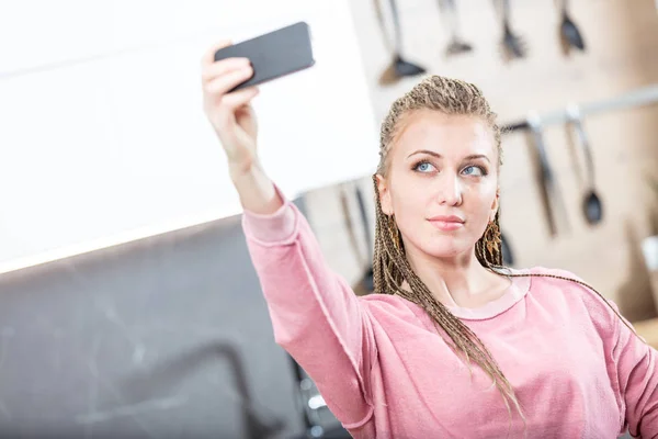 Woman making a selfie in the kitchen — Stock Photo, Image