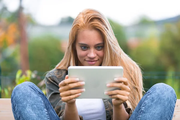 Funny faces f a shocked girl and a tablet — Stock Photo, Image