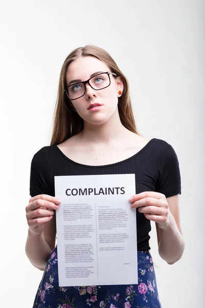 Serious young woman with a long list of Complaints — Stock Photo, Image