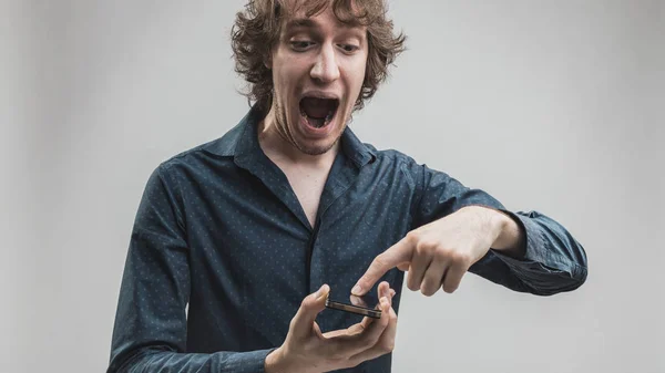 Mann amüsiert sich über seine Smartphone-Funktionen — Stockfoto