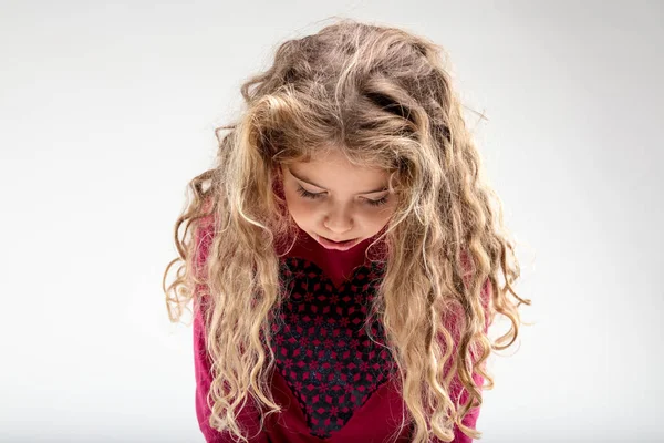 Triest curly-haired schoolmeisje met hoofd naar beneden — Stockfoto