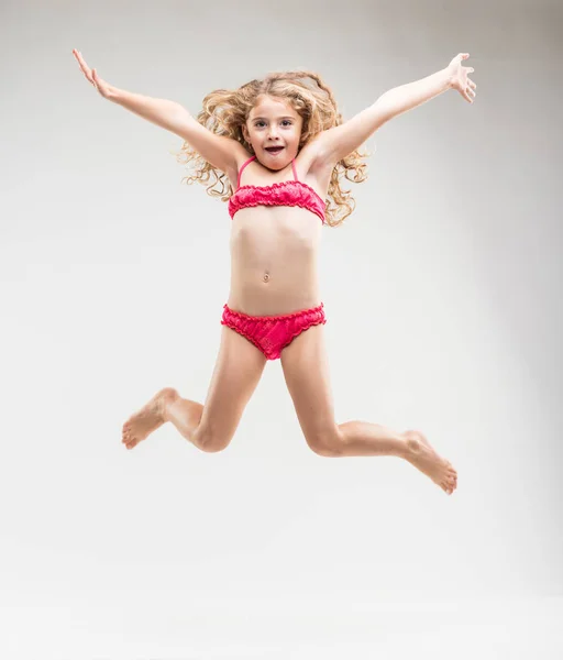 Agile exuberant little girl leaping in the air — Stock Image Agile exuberant little girl leaping in the air Royalty Free Stock Photos