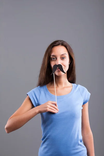 Fake carton moustaches on a pretty girl — Stock Photo, Image