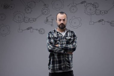 Confident bearded man with folded arms clipart