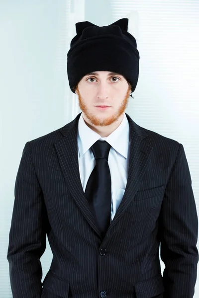 Strange businessman wearing a knitted cap and suit — Stock Photo, Image