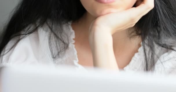 Vertical pan of a thoughtful young woman at laptop — Stock Video