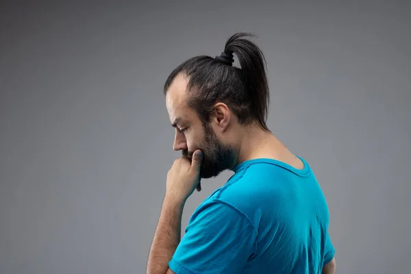 Pensive Bearded Man Blue Shirt Black Hair Ponytail Standing Hand — Stock Photo, Image