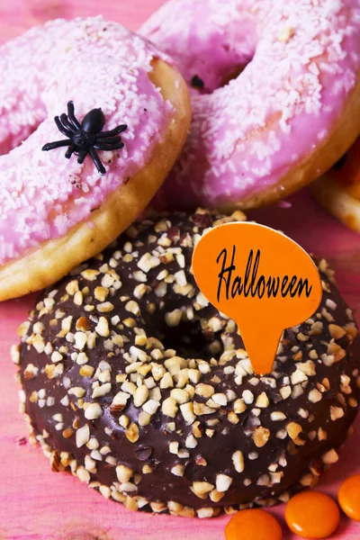 Halloween cukierki i słodycze na różowym tle — Zdjęcie stockowe