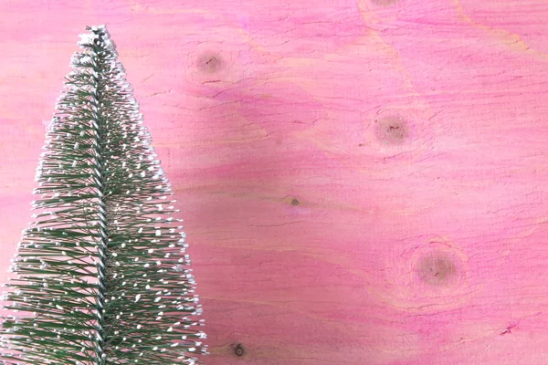 ピンクの木製の背景上にクリスマス ツリー — ストック写真