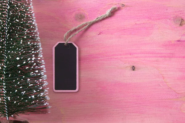 Árbol de Navidad sobre fondo de madera rosa con etiqueta —  Fotos de Stock