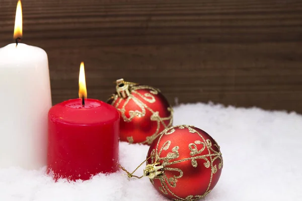 Christmas card with candles and Christmas decorations in the snow Stock Image
