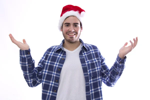 Ung man med hatt av jultomten genom att höja handen — Stockfoto