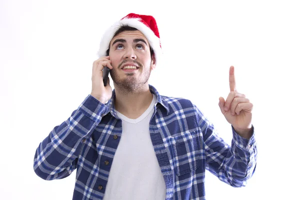 Junger Mann mit Weihnachtsmann am Handy und Hut — Stockfoto
