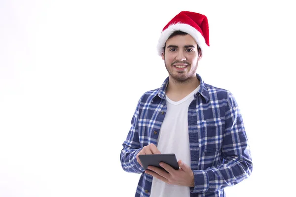 Junger Mann mit Weihnachtsmann-Hut und Tablette — Stockfoto