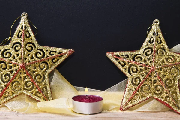 Blackboard with candles and stars on the snow — Stock Photo, Image