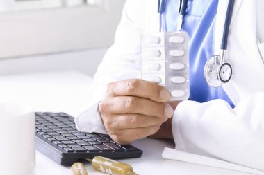 Doktor ilaçlarla birlikte elinde