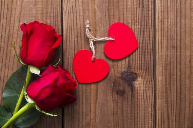 Ahşap arka plan üzerinde etiket ve kırmızı güller