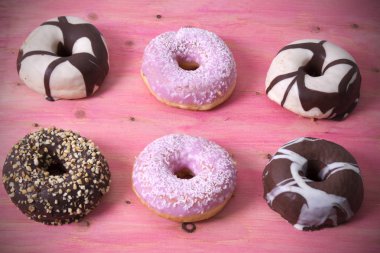 ahşap pembe üzerinde renkli donut topluluğu