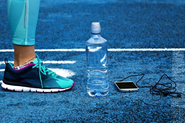 woman on track with mobile phone