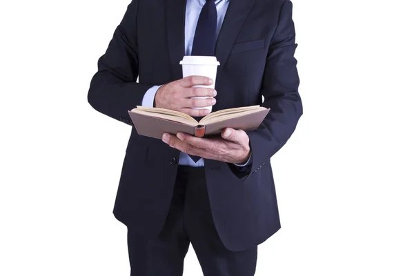 Uomo d'affari con tazza di caffè e libro — Foto Stock