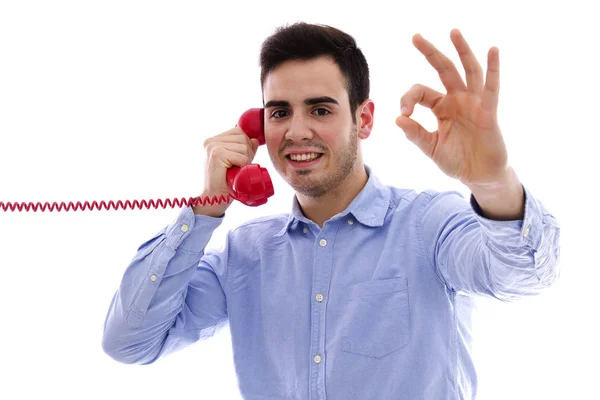 Ung man med röd telefon gör ett ok tecken — Stockfoto