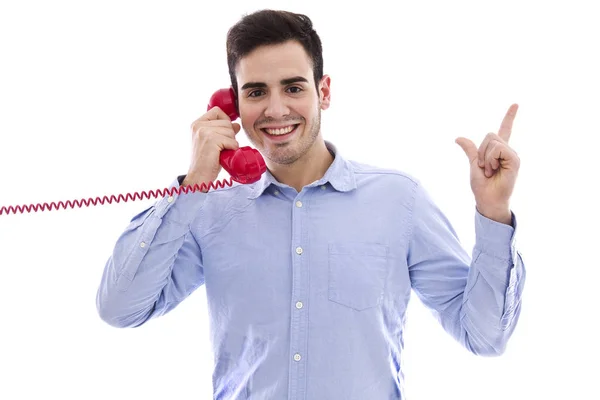 Joven con el teléfono rojo apuntando con el dedo — Foto de Stock