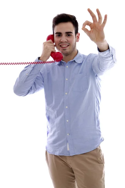Jovem com telefone vermelho fazendo símbolo ok — Fotografia de Stock