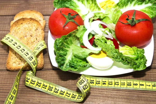 Tasty salad plate on wood — Stock Photo, Image