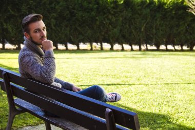 genç adam bir bankta düşünme