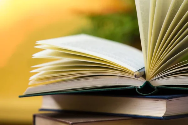 Open books on yellow background — Stock Photo, Image